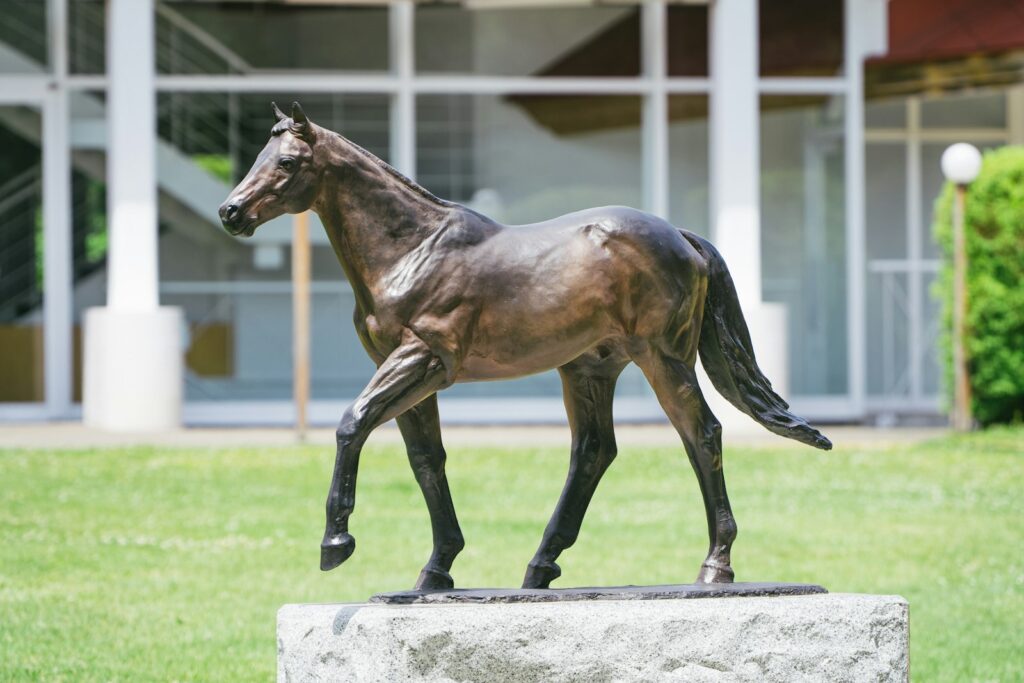 Elegant bronze horse statue on a stone pedestal, showing the horse as a lasting subject in sculpture